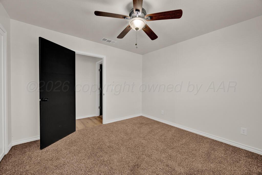 8027 Simpson Drive Amarillo, TX 79121 - Photo 18 of 32 an empty room with closet and fan