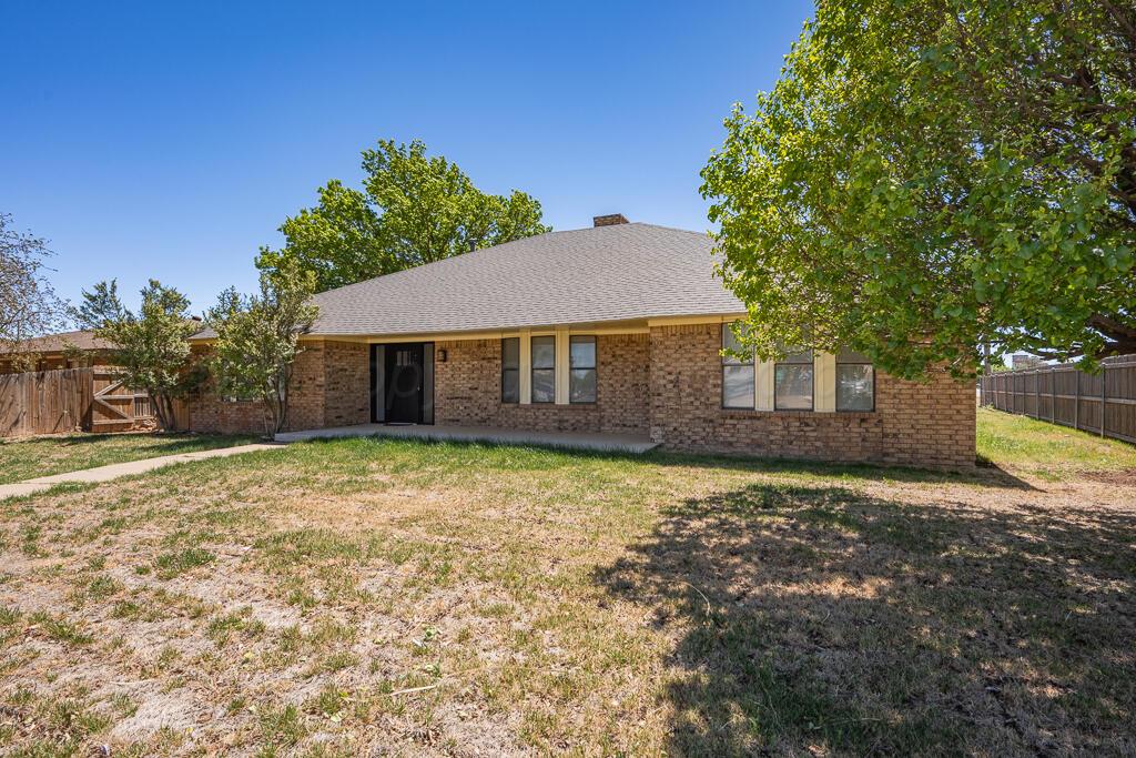 8027 Simpson Drive Amarillo, TX 79121 - Photo 2 of 32 a front view of a house with a garden