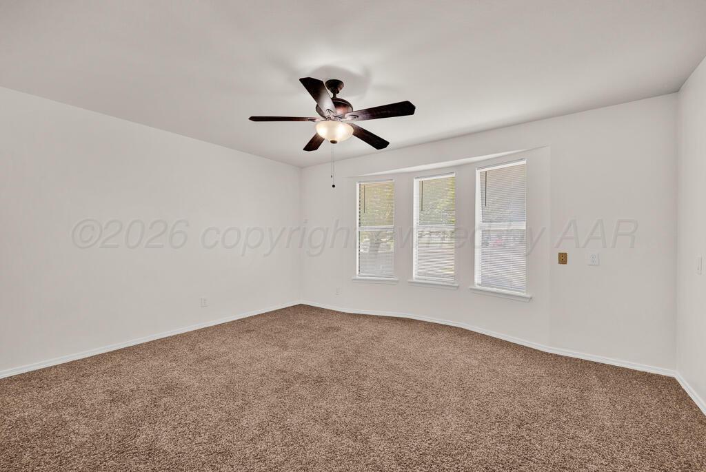 8027 Simpson Drive Amarillo, TX 79121 - Photo 21 of 32 wooden floor in an empty room with a window