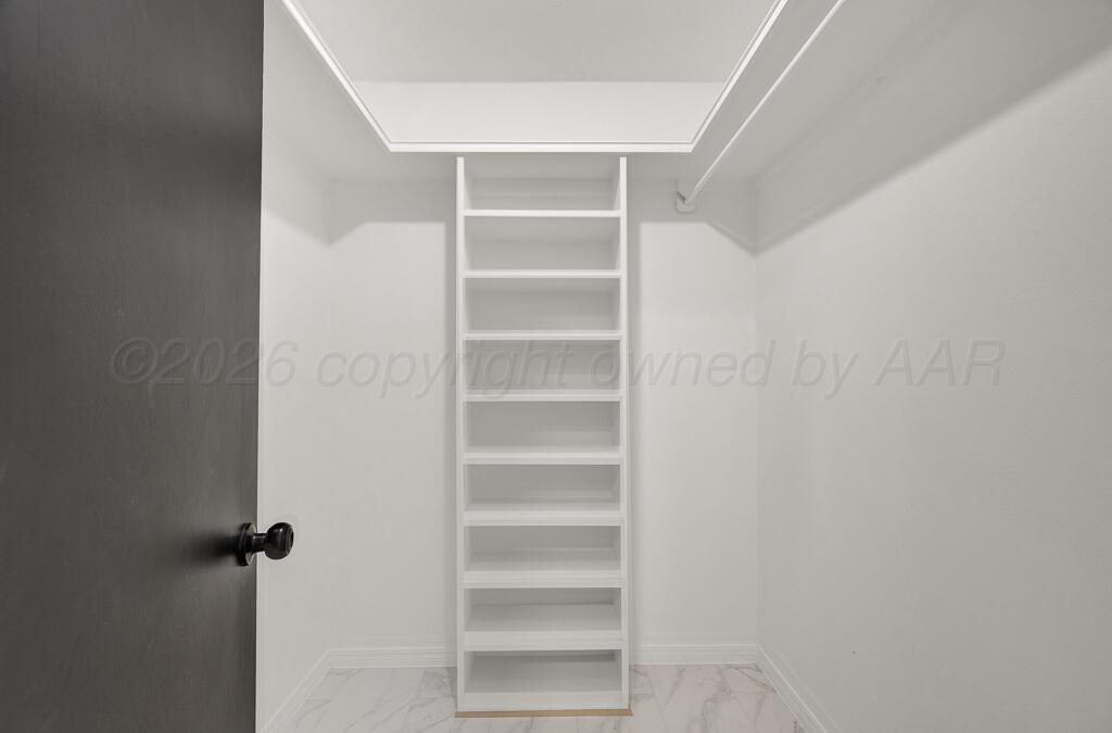 8027 Simpson Drive Amarillo, TX 79121 - Photo 28 of 32 a view of walk in closet with empty racks