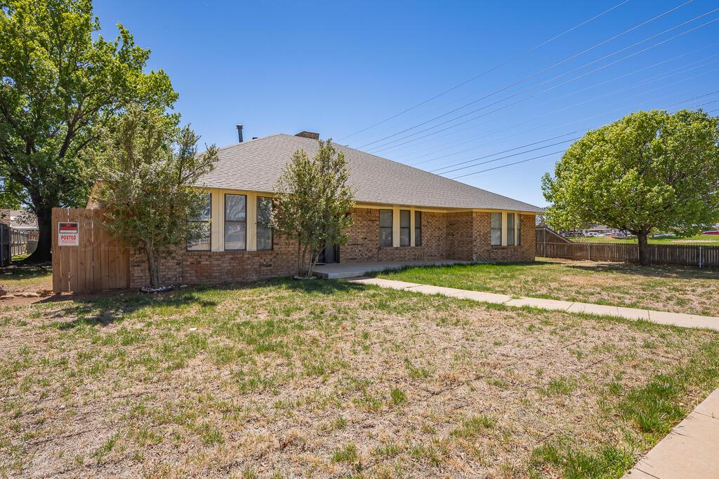 8027 Simpson Drive Amarillo, TX 79121 - Photo 3 of 32 a front view of a house with a yard