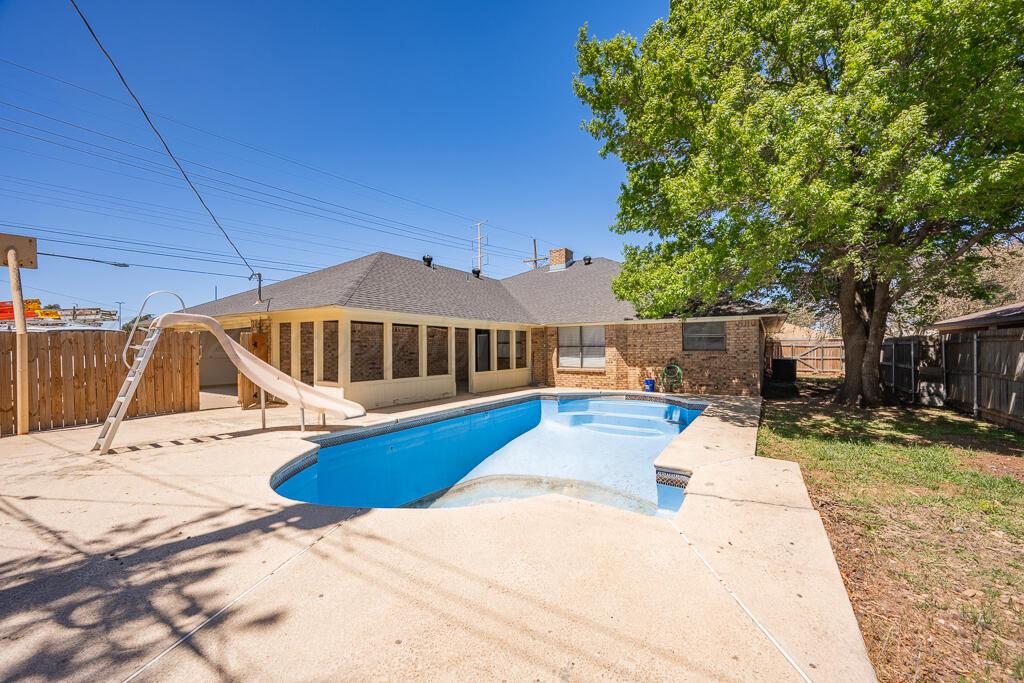 8027 Simpson Drive Amarillo, TX 79121 - Photo 31 of 32 a view of a house with swimming pool