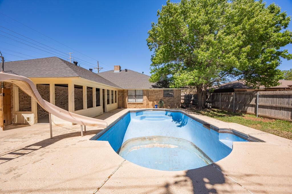 8027 Simpson Drive Amarillo, TX 79121 - Photo 32 of 32 a view of a swimming pool with a lounge chair