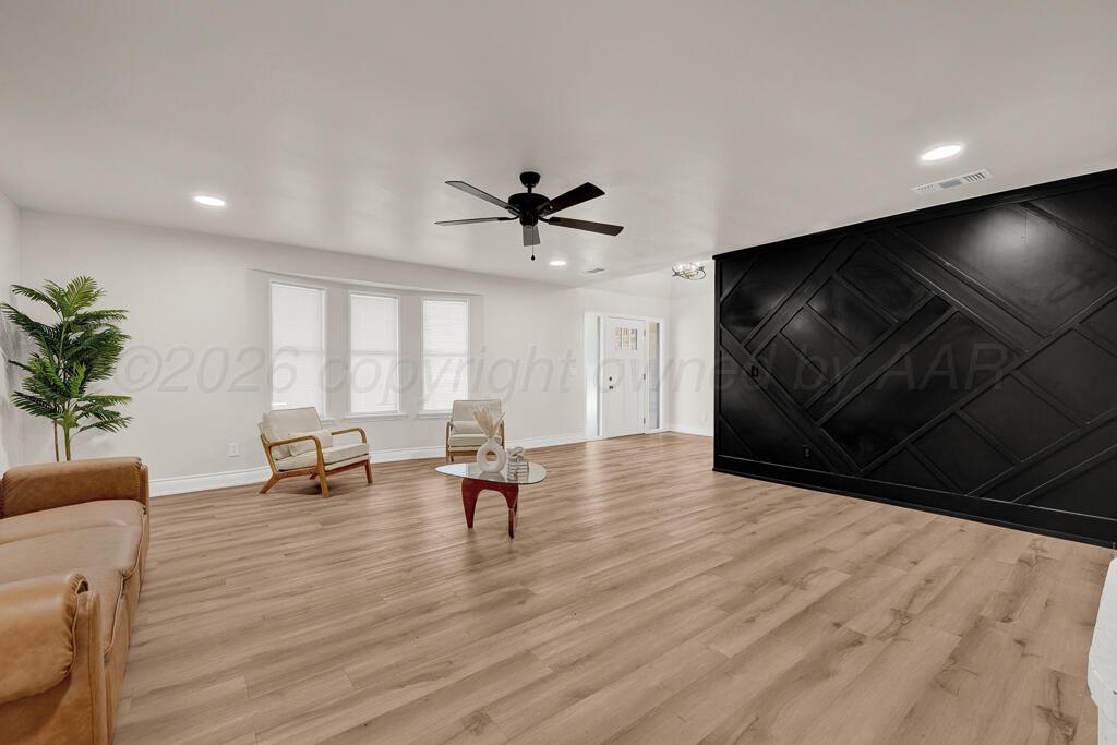 8027 Simpson Drive Amarillo, TX 79121 - Photo 5 of 32 a living room with furniture and a flat screen tv