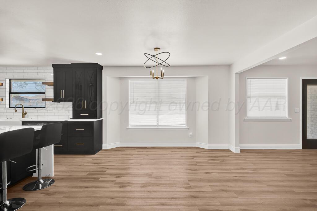 8027 Simpson Drive Amarillo, TX 79121 - Photo 10 of 32 a view of kitchen with wooden floor and electronic appliances
