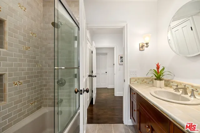 a bedroom with two beds and a flat screen tv