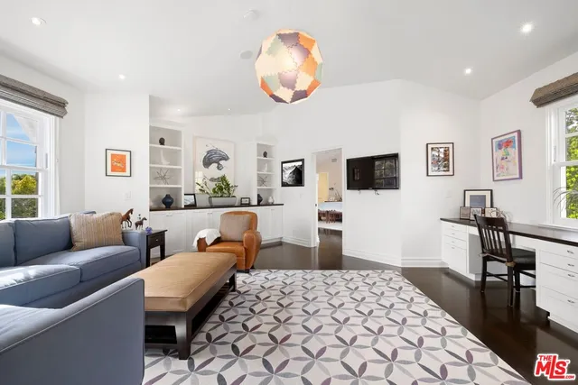a living room with furniture fireplace and flat screen tv
