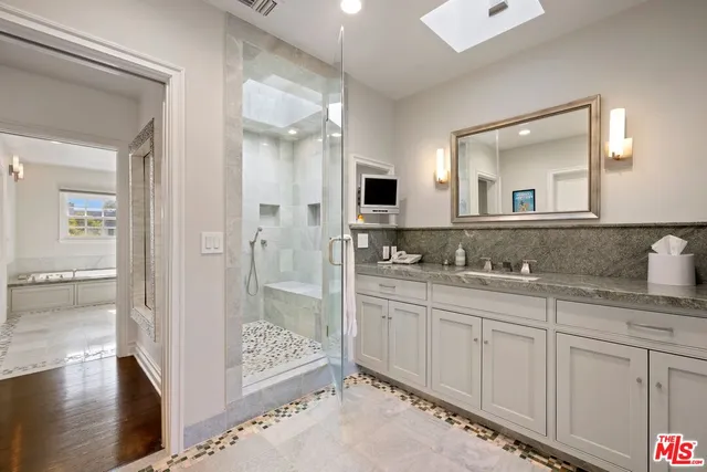a bathroom with a bathtub and a shower