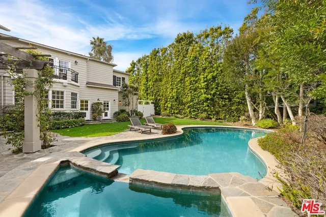 a view of backyard with swimming pool and outdoor seating