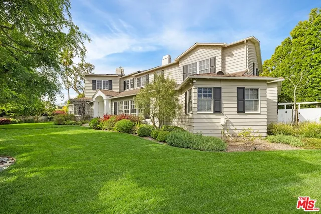 a living room with furniture large window and wooden floor