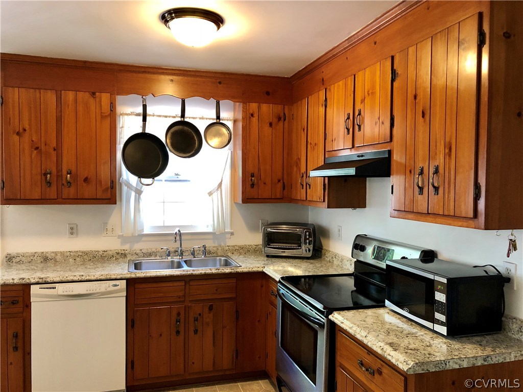 10612 Tokay Road Chesterfield, VA 23832 - Photo 12 of 18 a kitchen with granite countertop a stove a sink dishwasher and cabinets with wooden floor