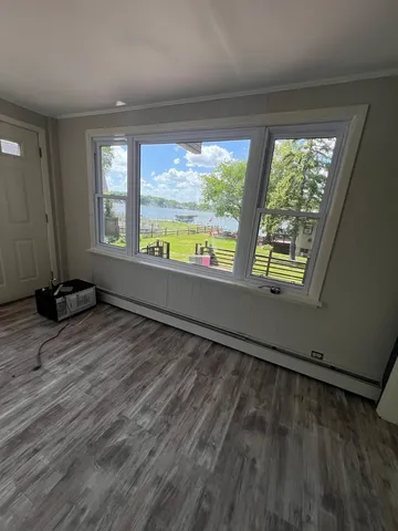 a view of an empty room and a window
