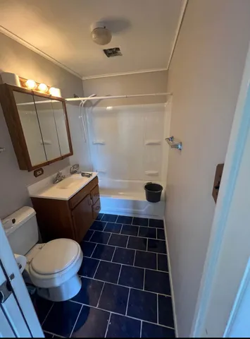 a bathroom with a toilet a sink and a shower