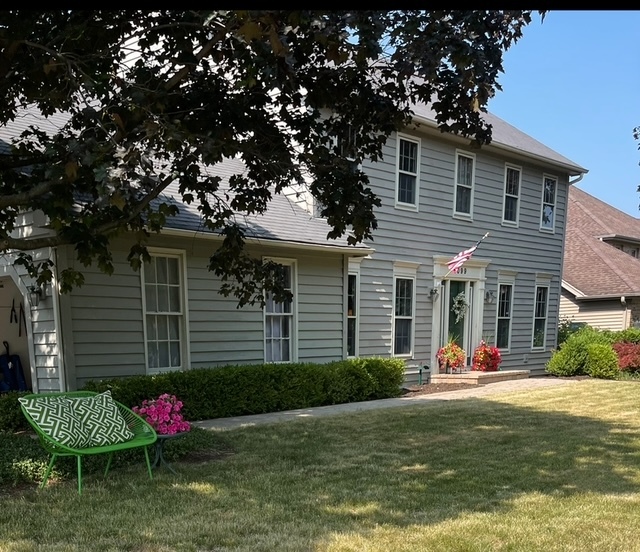 1099 West Jefferson Avenue Naperville, IL 60540 - Photo 1 of 19 a front view of a house with garden