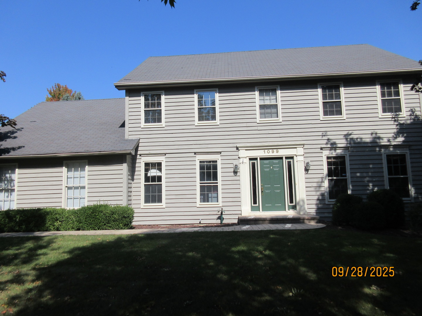 1099 West Jefferson Avenue Naperville, IL 60540 - Photo 2 of 19 a front view of a house with a garden
