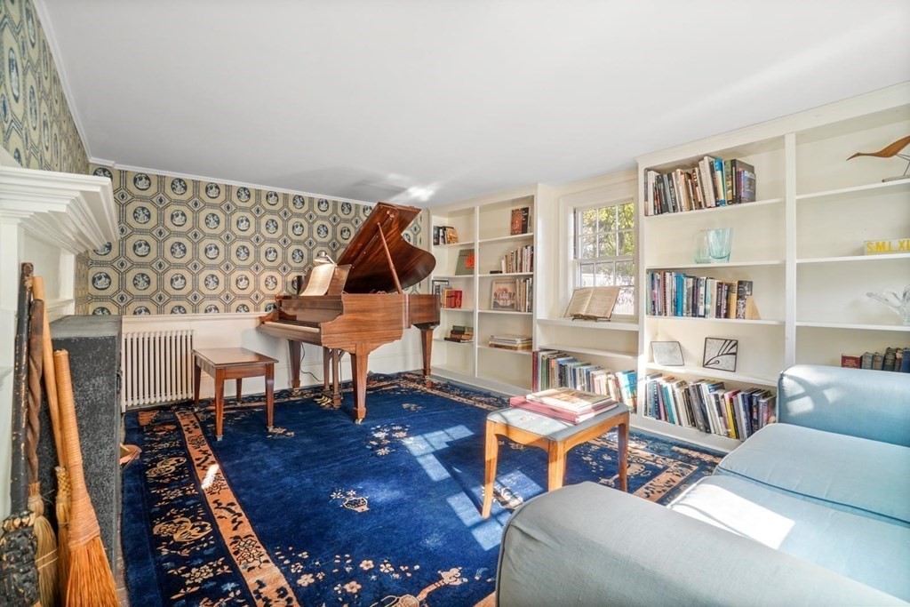 1219 High Street Westwood, MA 02090 - Photo 12 of 30 a living room with furniture a rug and a bookshelf