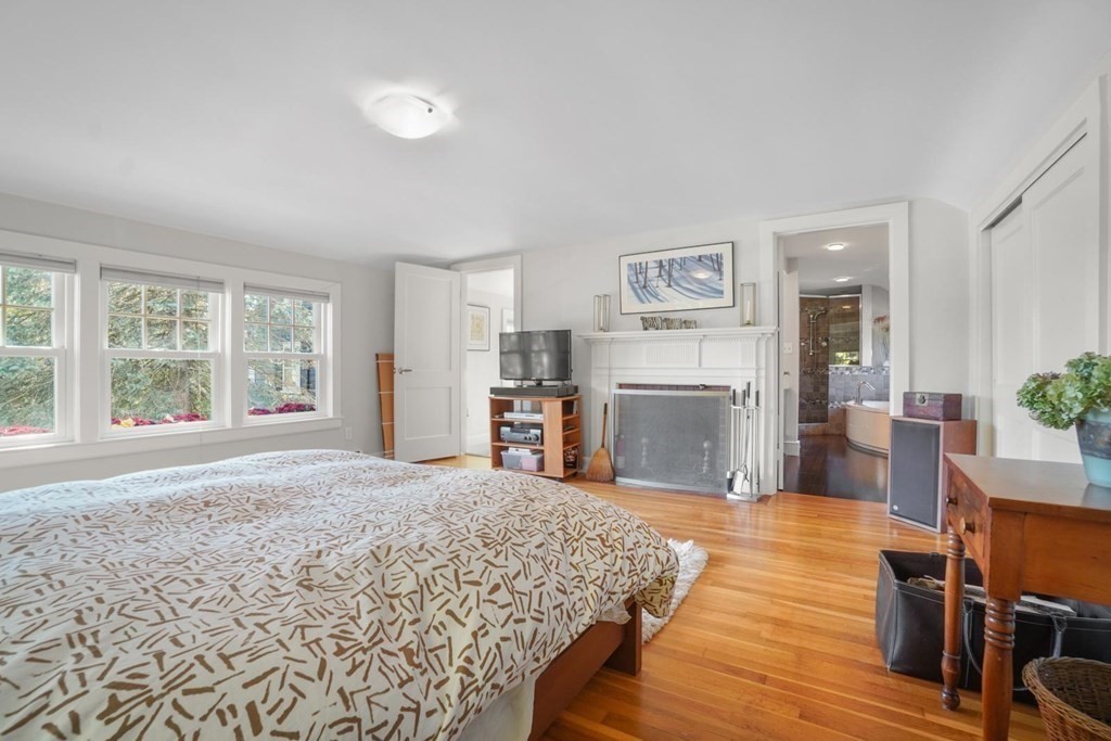 1219 High Street Westwood, MA 02090 - Photo 20 of 30 a spacious bedroom with a large bed and a wooden floor