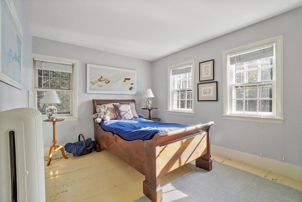 1219 High Street Westwood, MA 02090 - Photo 27 of 30 a bed sitting in a bedroom next to a window and a chair