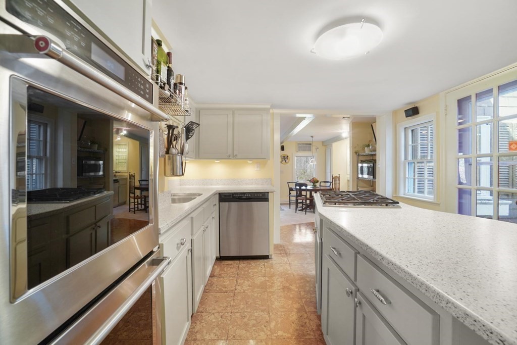 1219 High Street Westwood, MA 02090 - Photo 7 of 30 a large kitchen with a large counter top and stainless steel appliances