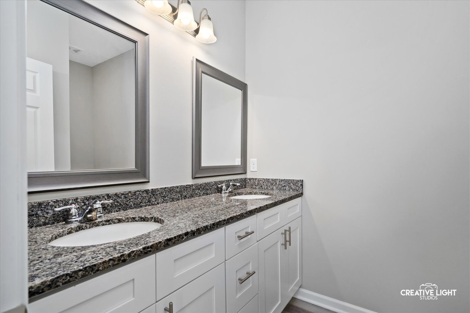 526 Hahn Drive Cortland, IL 60112 - Photo 11 of 20 a bathroom with a granite countertop sink and a mirror