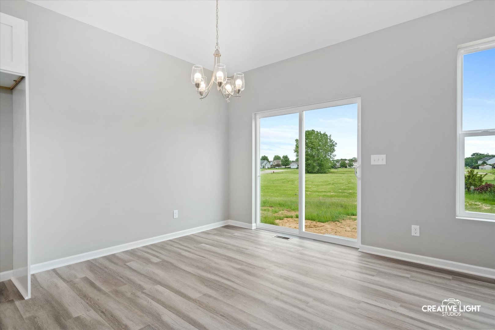 526 Hahn Drive Cortland, IL 60112 - Photo 6 of 20 a view of empty room with wooden floor and fan