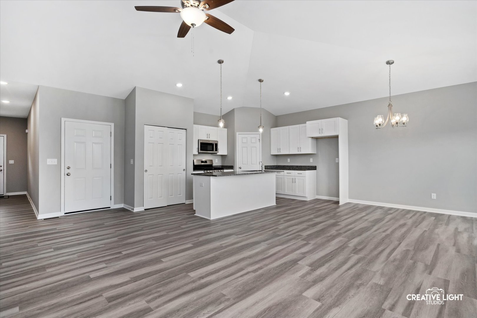 526 Hahn Drive Cortland, IL 60112 - Photo 8 of 20 an open kitchen with kitchen island white cabinets and stainless steel appliances