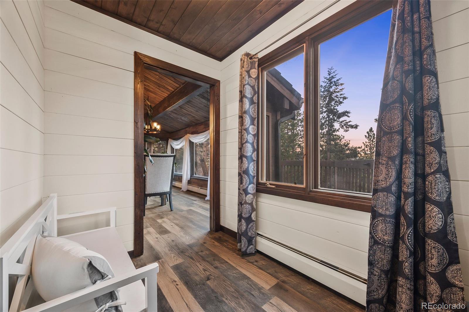 193 Mary Beth Road Evergreen, CO 80439 - Photo 13 of 46 a view of a balcony with wooden floor and stairs