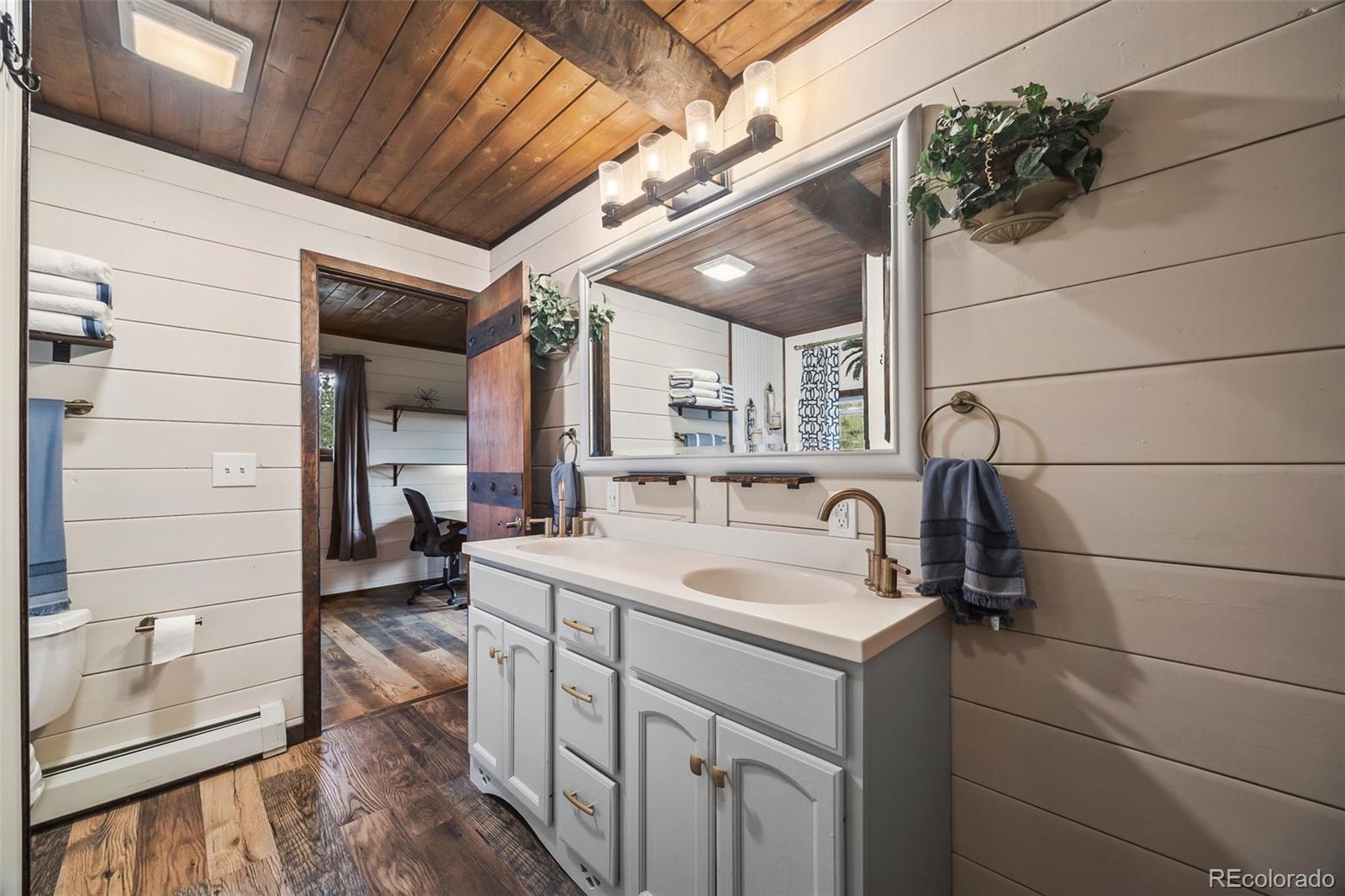 193 Mary Beth Road Evergreen, CO 80439 - Photo 21 of 46 a bathroom with a sink and mirror