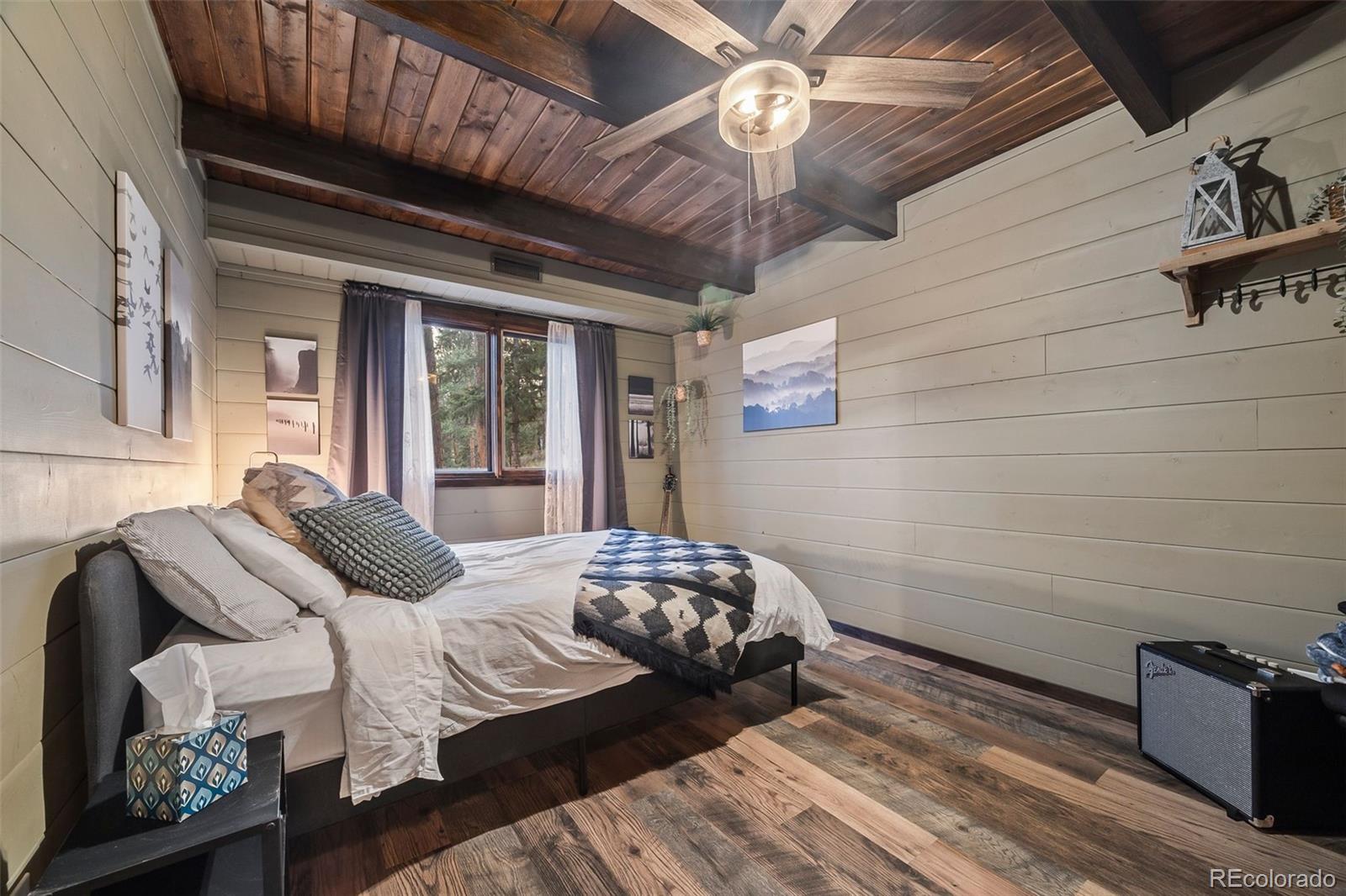 193 Mary Beth Road Evergreen, CO 80439 - Photo 23 of 46 a bedroom with a bed next to a window