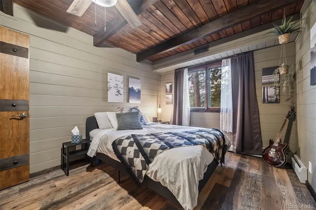 a bathroom with a granite countertop toilet sink and mirror