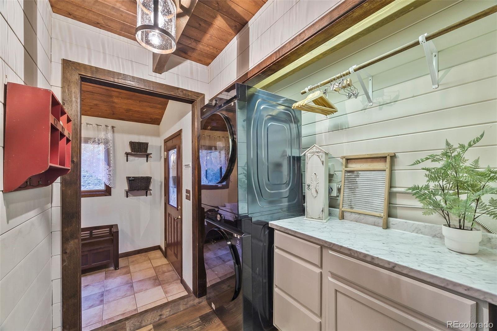 193 Mary Beth Road Evergreen, CO 80439 - Photo 27 of 46 a bathroom with a granite countertop sink a mirror and shower