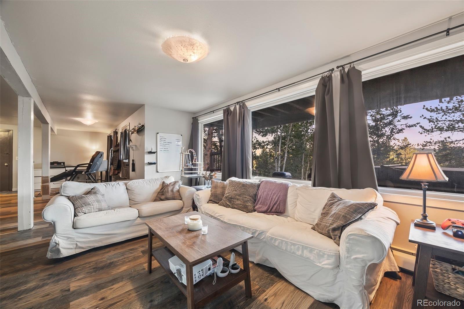 193 Mary Beth Road Evergreen, CO 80439 - Photo 28 of 46 a living room with furniture and a large window