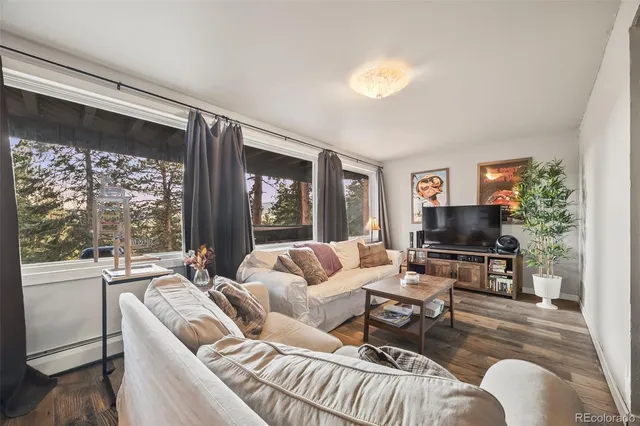 a living room with furniture a table and chairs