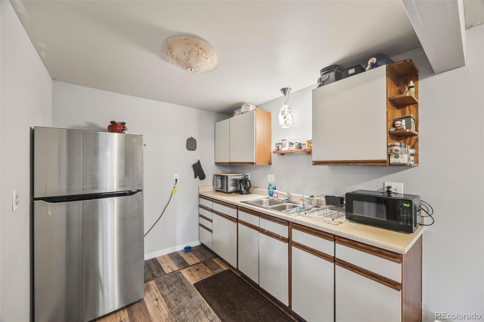 193 Mary Beth Road Evergreen, CO 80439 - Photo 31 of 46 a kitchen with a refrigerator and a sink