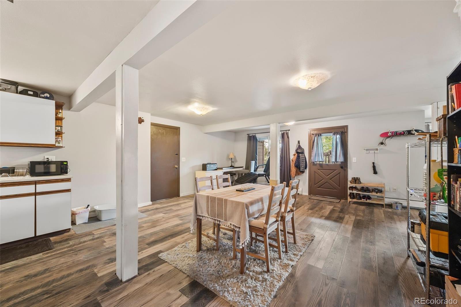 193 Mary Beth Road Evergreen, CO 80439 - Photo 32 of 46 a view of a dining room with furniture and wooden floor