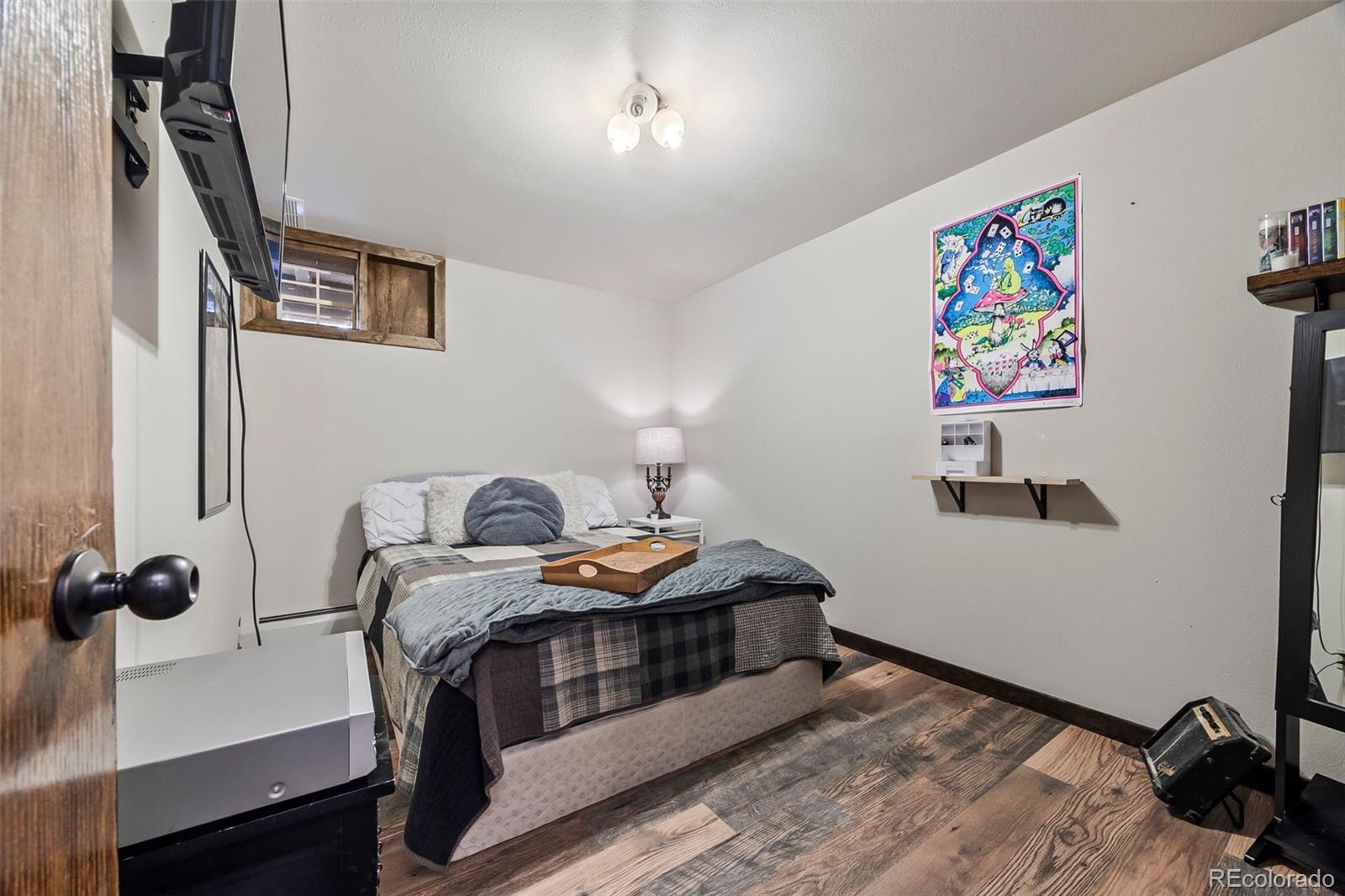 193 Mary Beth Road Evergreen, CO 80439 - Photo 34 of 46 a bedroom with a bed and a book shelf