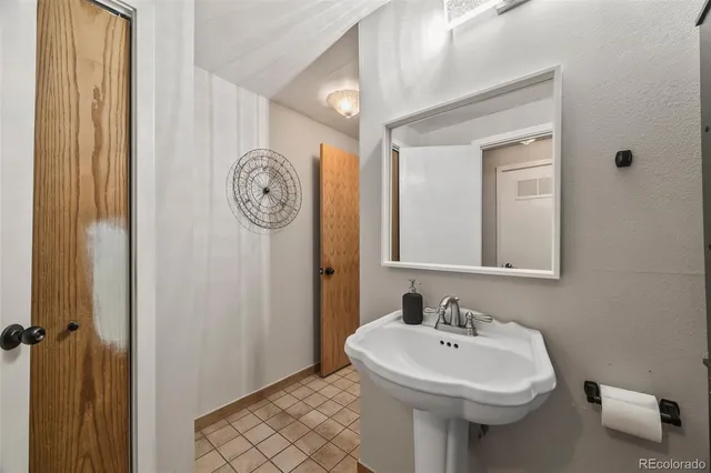 a balcony with wooden floor table and chairs