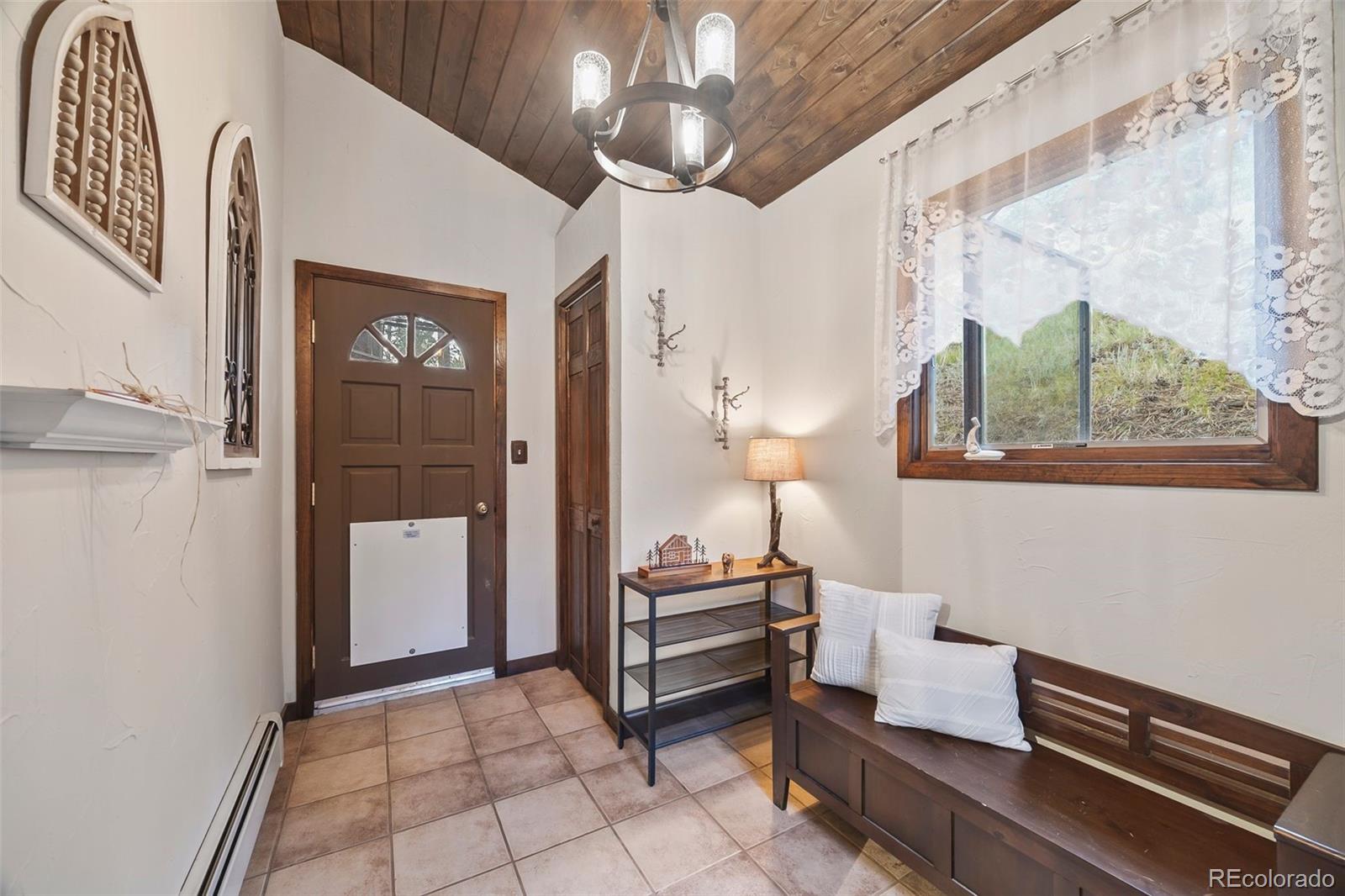 193 Mary Beth Road Evergreen, CO 80439 - Photo 4 of 46 a room with furniture and a chandelier