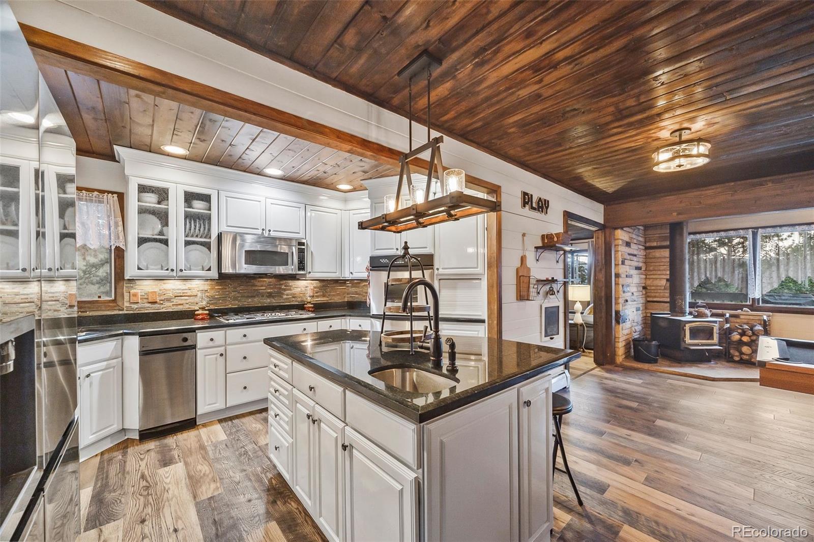 193 Mary Beth Road Evergreen, CO 80439 - Photo 7 of 46 a kitchen with stainless steel appliances granite countertop a sink and cabinets