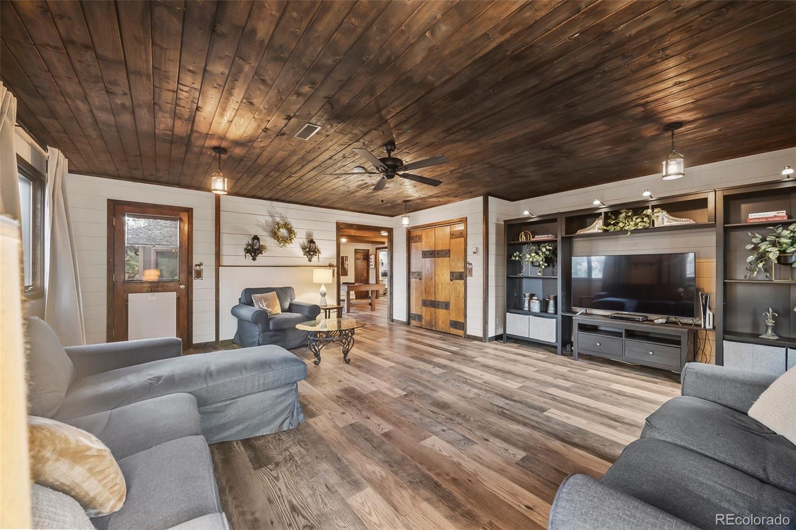 193 Mary Beth Road Evergreen, CO 80439 - Photo 10 of 46 a living room with furniture and a flat screen tv