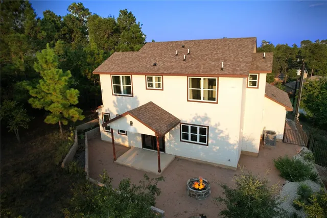 a aerial view of a house with table and chairs in patio