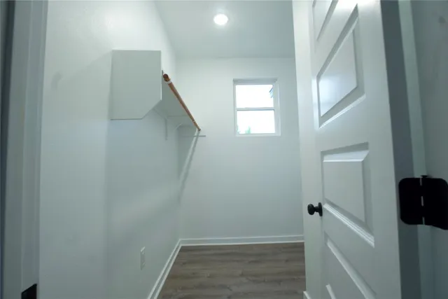 a view of hallway with stairs and wooden floor