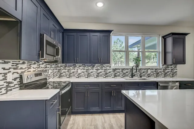 a kitchen with a sink stove and cabinets