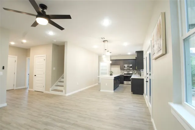 a view of a living room kitchen and a refrigerator