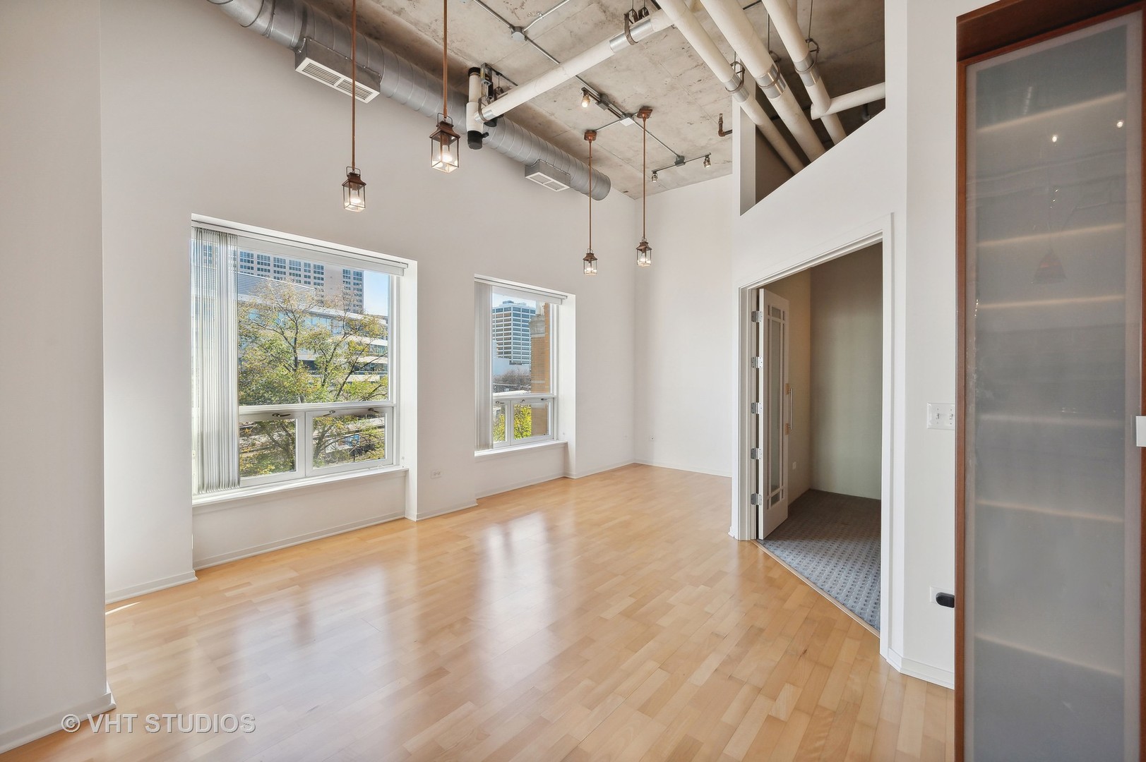 1640 Maple Avenue, Unit 401 Evanston, IL 60201 - Photo 8 of 21 a view of a big room with windows and chandelier
