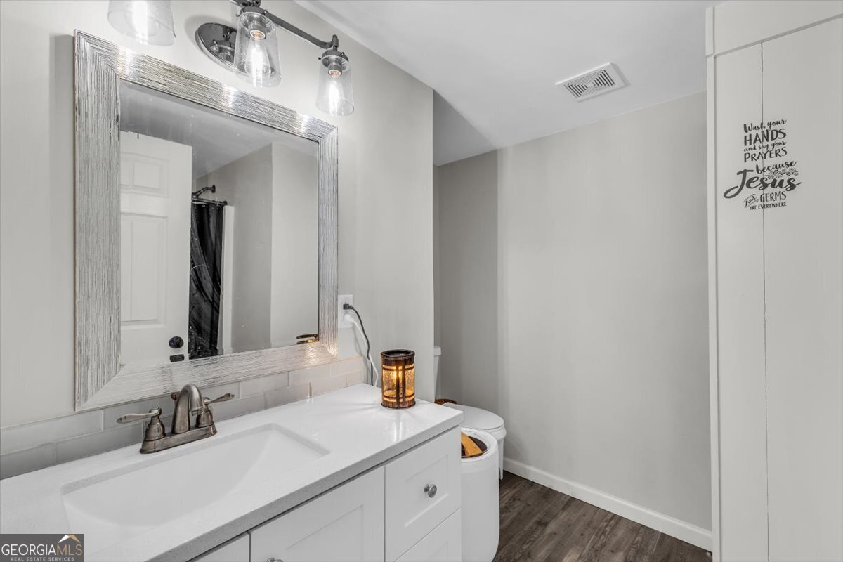 424 Gilford Street Jesup, GA 31546 - Photo 14 of 15 a bathroom with a sink and a mirror