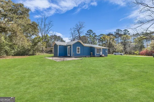 a view of a house with backyard and garden