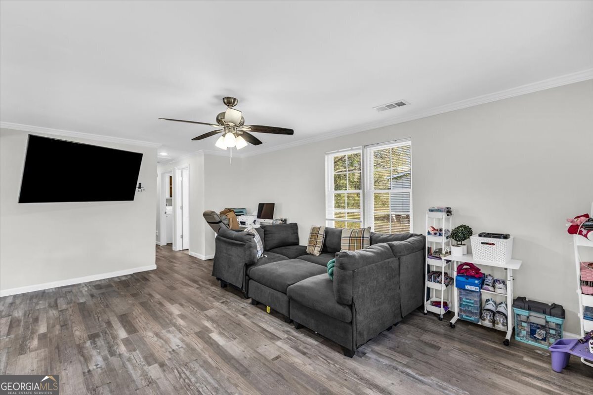 424 Gilford Street Jesup, GA 31546 - Photo 6 of 15 a living room with furniture and a flat screen tv