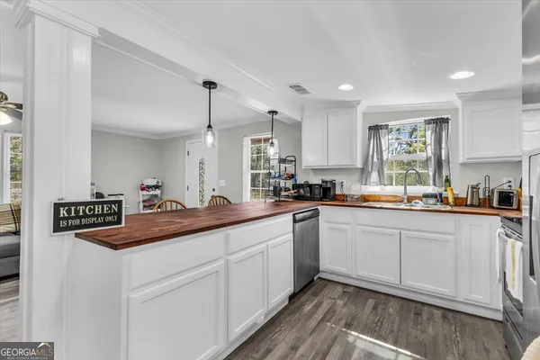 a kitchen with granite countertop white cabinets and white appliances