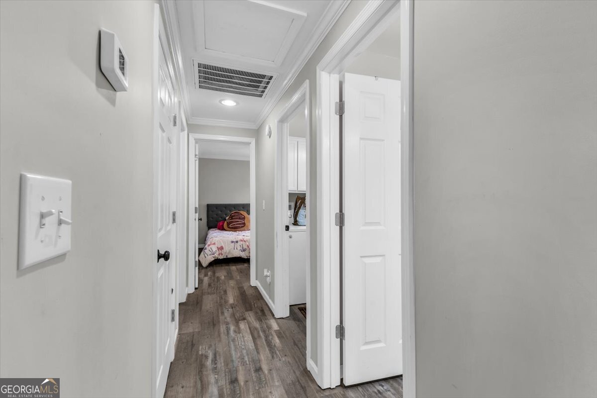 424 Gilford Street Jesup, GA 31546 - Photo 10 of 15 a view of a hallway with wooden floor and staircase
